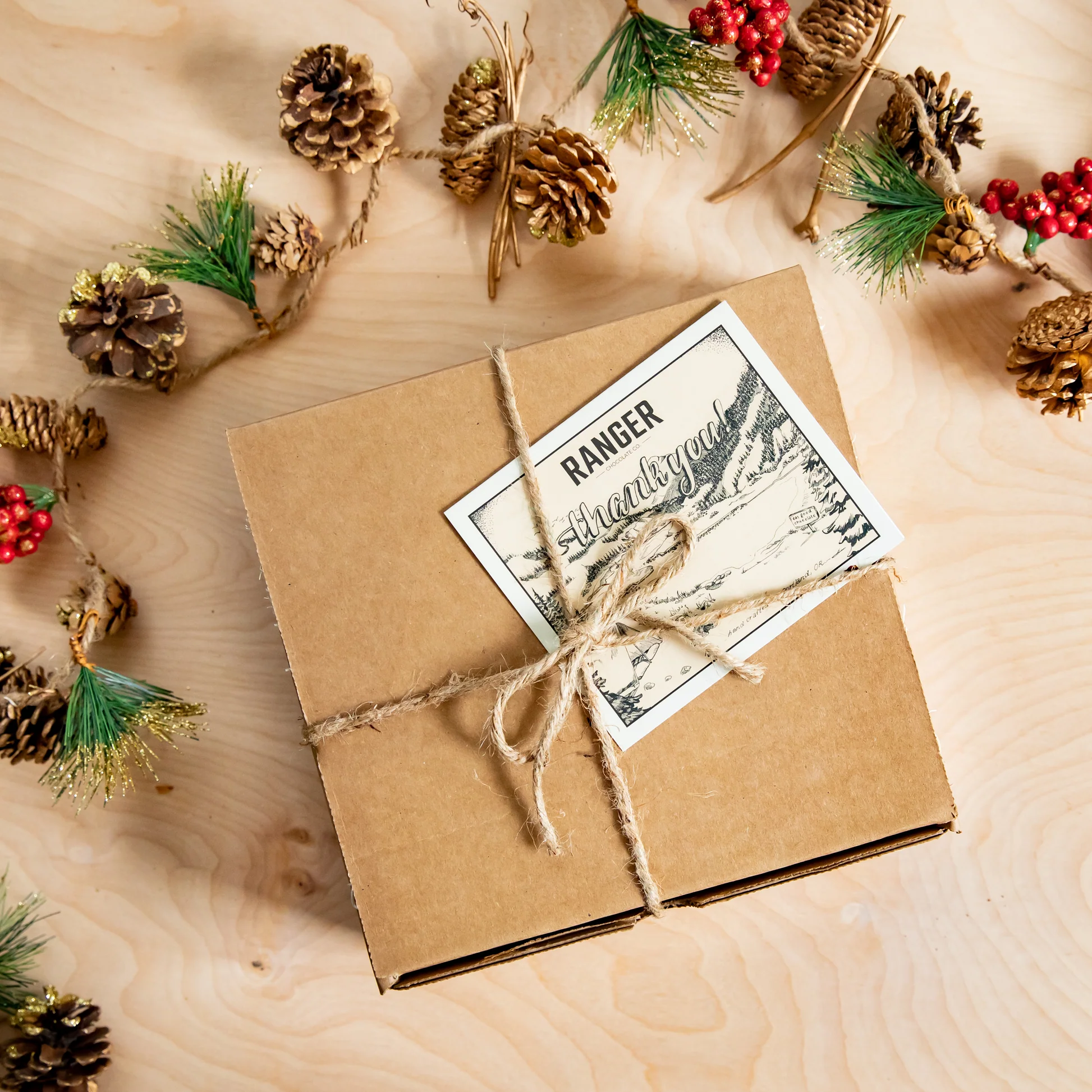A Ranger Chocolate Co. gift box wrapped with twine and a thank-you card