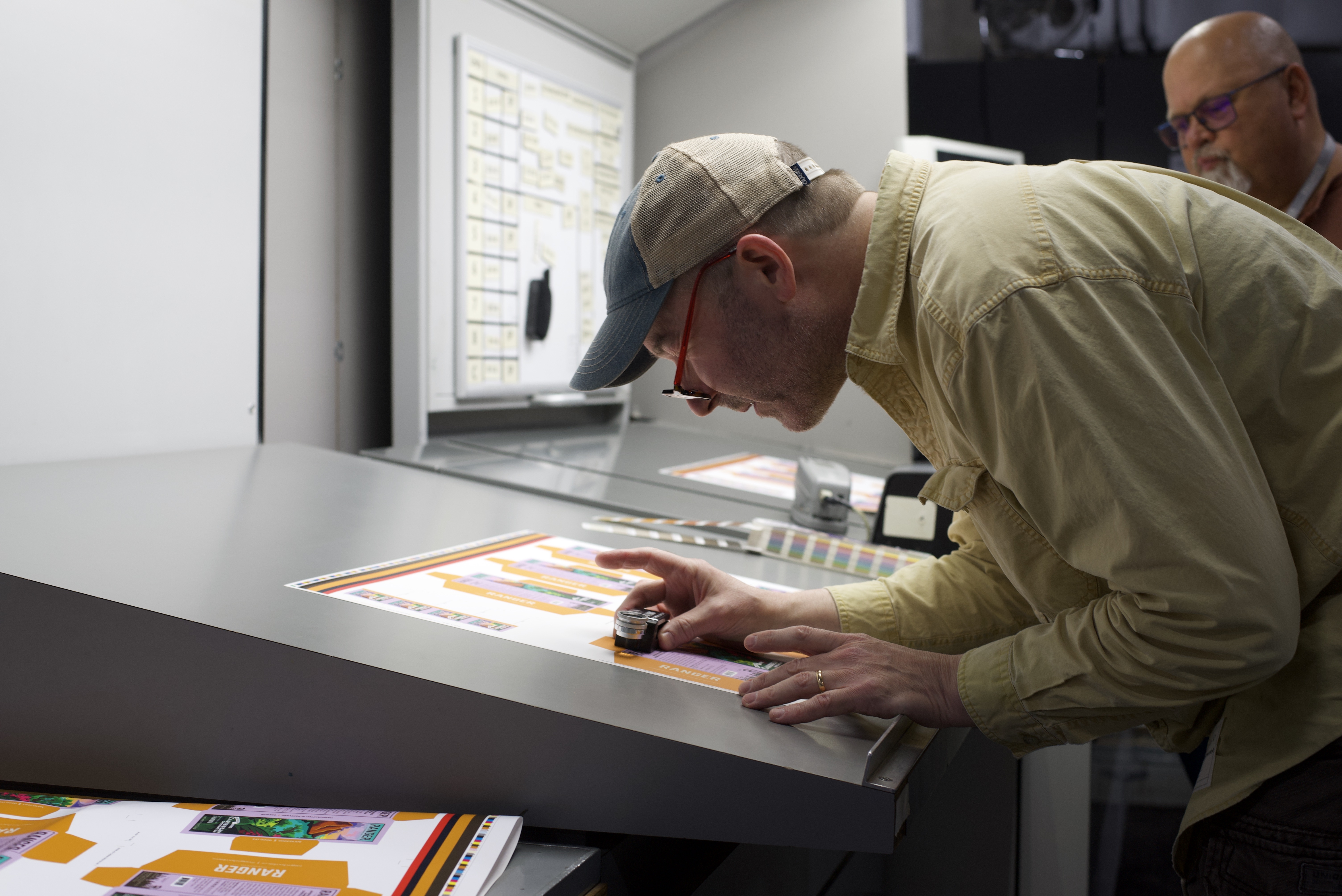 Ranger Chocolate Co. team members reviewing printed packaging at a production press